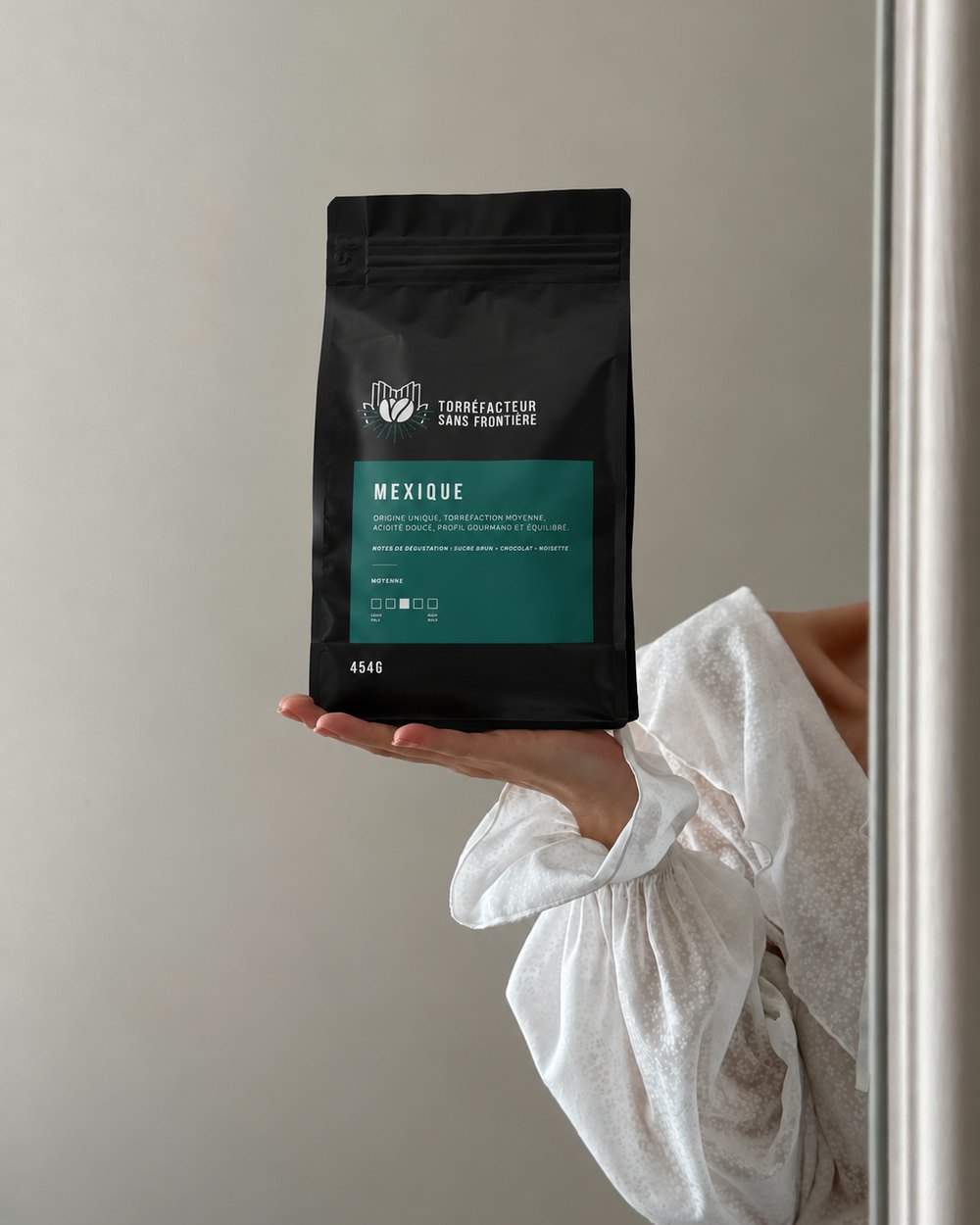 Main tenant un sac de café Mexique 454 g torréfié en Abitibi par Torréfacteur sans frontière